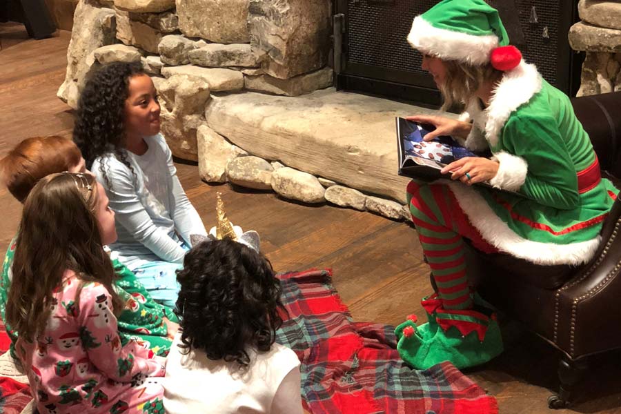 Elf reading a holiday story to children