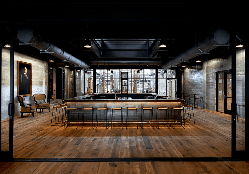 a luxury modern bar with wooden floors, big ceilings and windows, with a bar in the center and portrait of a man on the wall.